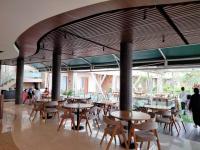 a restaurant with tables and chairs and people in the background at Villa Rancabango Hotel & Resort Garut in Tarogong