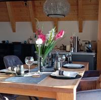 a wooden table with a vase of flowers on it at Villa Florentina in Bad Wörishofen