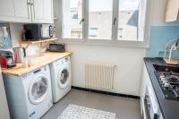 a kitchen with a washer and dryer in a kitchen at Les Hirondelles By Nid&#39;Ouest in Quimper