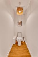 a bathroom with a toilet and a chandelier at ZenBNB - Évasion - Colocation - Ch 39 - Proche Transport in Annemasse