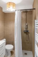 a bathroom with a shower with a toilet and a chandelier at ZenBNB - Évasion - Colocation - Ch 39 - Proche Transport in Annemasse