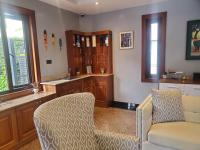 a living room with a couch and a chair at Deerpark Luxury Stays in Nairobi