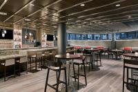 a restaurant with tables and chairs and a bar at Delta Hotels by Marriott Ashland Downtown in Ashland