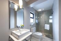 a bathroom with a sink and a toilet and a shower at Deerpark Luxury Stays in Nairobi