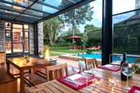 a patio with a table and chairs and a pool at Deerpark Luxury Stays in Nairobi