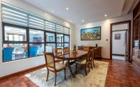 a dining room with a table and chairs at Deerpark Luxury Stays in Nairobi