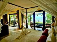 Postel nebo postele na pokoji v ubytování Cinnamon Beach Villas