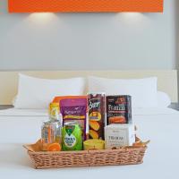 a basket of food and drinks on a bed at HARRIS Hotel Batam Center in Batam Center