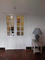 a room with a door and a lamp on a table at La Quiétude in Cotignac
