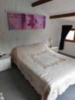 a bedroom with a large bed with a white comforter at La Quiétude in Cotignac