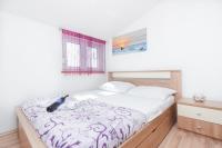 Posteľ alebo postele v izbe v ubytovaní Apartman Lara