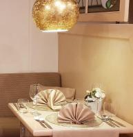 a table with a white table cloth and a gold chandelier at Haus Roseneck mit gratis Zugang zur Jod-Sole-Therme in Bad Bevensen