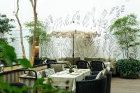 a restaurant with tables and chairs and an umbrella at Casa Polanco Hotel Boutique in Mexico City