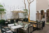 a restaurant with tables and chairs and a wall at Casa Polanco Hotel Boutique in Mexico City