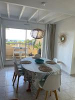 a dining room with a table and chairs in a room at Plage de rêve et tennis devant la maison in Pornichet