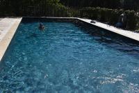 a person in the water in a swimming pool at La Figalie in Saint Jean du Pin