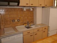 a small kitchen with a sink and a refrigerator at Appartement Esquièze-Sère, 3 pièces, 4 personnes - FR-1-402-82 in Esquièze - Sère