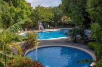 a large swimming pool with a slide in the middle at Hotel Boyeros in Liberia