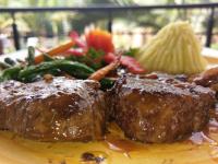 a plate of food with meat and pasta and vegetables at Shangri-la Hotel Muyenga in Bugolobi