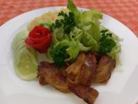 a white plate of food with chicken lettuce and vegetables at Shangri-la Hotel Muyenga in Bugolobi