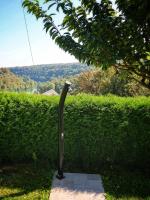 a metal pole in the grass next to a hedge at Kuća za odmor Miracool in Generalski Stol
