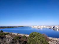 a large body of water with a city in the background at Villa piscine privée superbe Vue Etang Leucate 8JBART580 in Port Leucate