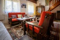a living room with red chairs and a table at Svjetlost in Jahorina