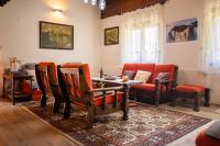 a living room with orange chairs and a table at Svjetlost in Jahorina