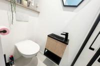 a bathroom with a toilet and a wooden box on the wall at Studio 1 Ananas cosy proche plages et commerces in Saint-Nazaire