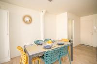 a dining room with a blue table and chairs at Foyal City Center in Fort-de-France