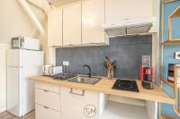 a kitchen with a sink and a refrigerator at Foyal City Center in Fort-de-France