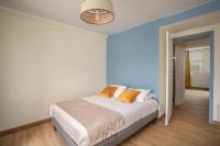 a bedroom with a white bed with orange pillows at Foyal City Center in Fort-de-France