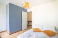 a bedroom with a white bed and a blue wall at Foyal City Center in Fort-de-France
