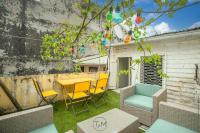 a patio with a table and chairs in a yard at Foyal City Center in Fort-de-France