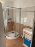 a shower with a glass door in a bathroom at La cabine d&#39;Amélie in Veules-les-Roses