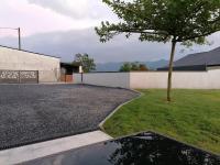 a driveway with a tree next to a building at Gîte entre mer et montagne in Saint-Vincent