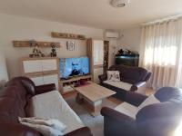a living room with two couches and a flat screen tv at Airport Apartment in Surčin