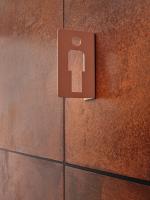 a sign on a brick wall with a key on it at CityHub Amsterdam in Amsterdam