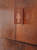a sign on a wall with an arrow on it at CityHub Amsterdam in Amsterdam