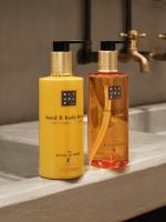 two bottles of hand and body lotion sitting on a sink at CityHub Amsterdam in Amsterdam
