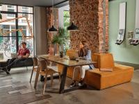 two people sitting at a table with their laptops at CityHub Amsterdam in Amsterdam