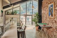 a room with a brick wall and a table and chairs at CityHub Amsterdam in Amsterdam