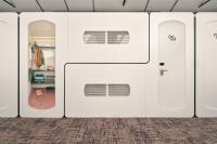 a row of white garage doors in a room at CityHub Amsterdam in Amsterdam