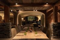 a dining room with a long table and chairs at Zannier Hotels Le Chalet in Megève