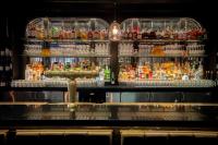 a bar with a lot of bottles of alcohol at Roxy Hotel New York in New York