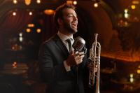 a man in a suit singing into a microphone at Roxy Hotel New York in New York
