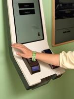 a person using an atm machine with their hand on it at CityHub Amsterdam in Amsterdam