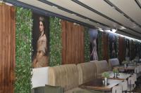 um restaurante com mesas e uma grande pintura na parede em Crown Salamis Hotel em Famagusta