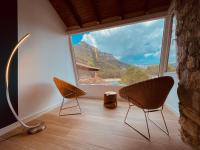 a room with two chairs and a large window at Moli l&#39;Abad in Puebla de Benifasar