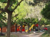 a park with a bunch of playground equipment and trees at Moli l&#39;Abad in Puebla de Benifasar